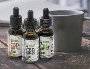 cbg-oils-3-with-a-cup-of-coffee.jpg