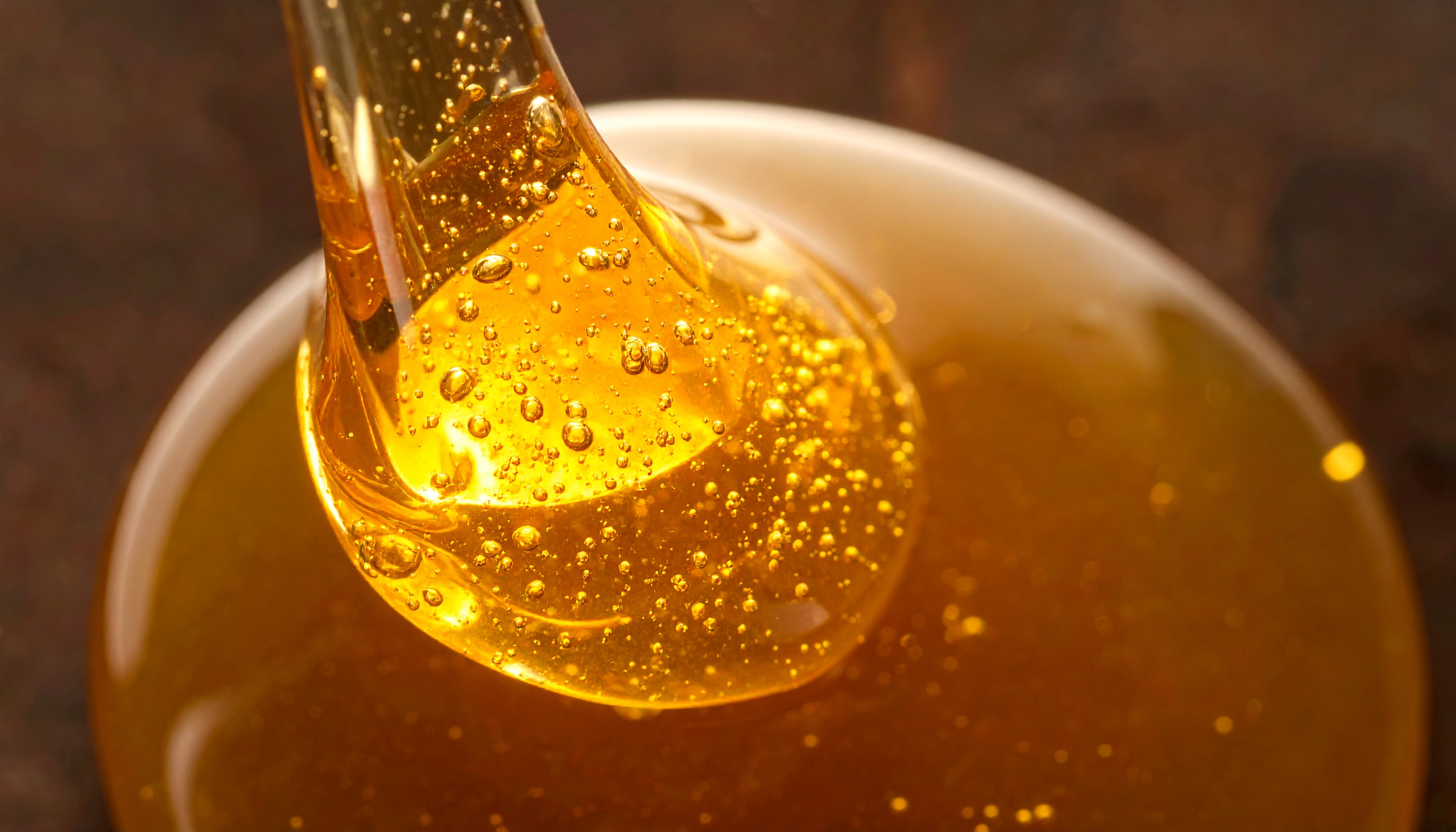 close up of organic tapioca syrup being poured in a thin stream  viscous and gol - Steve's Goods