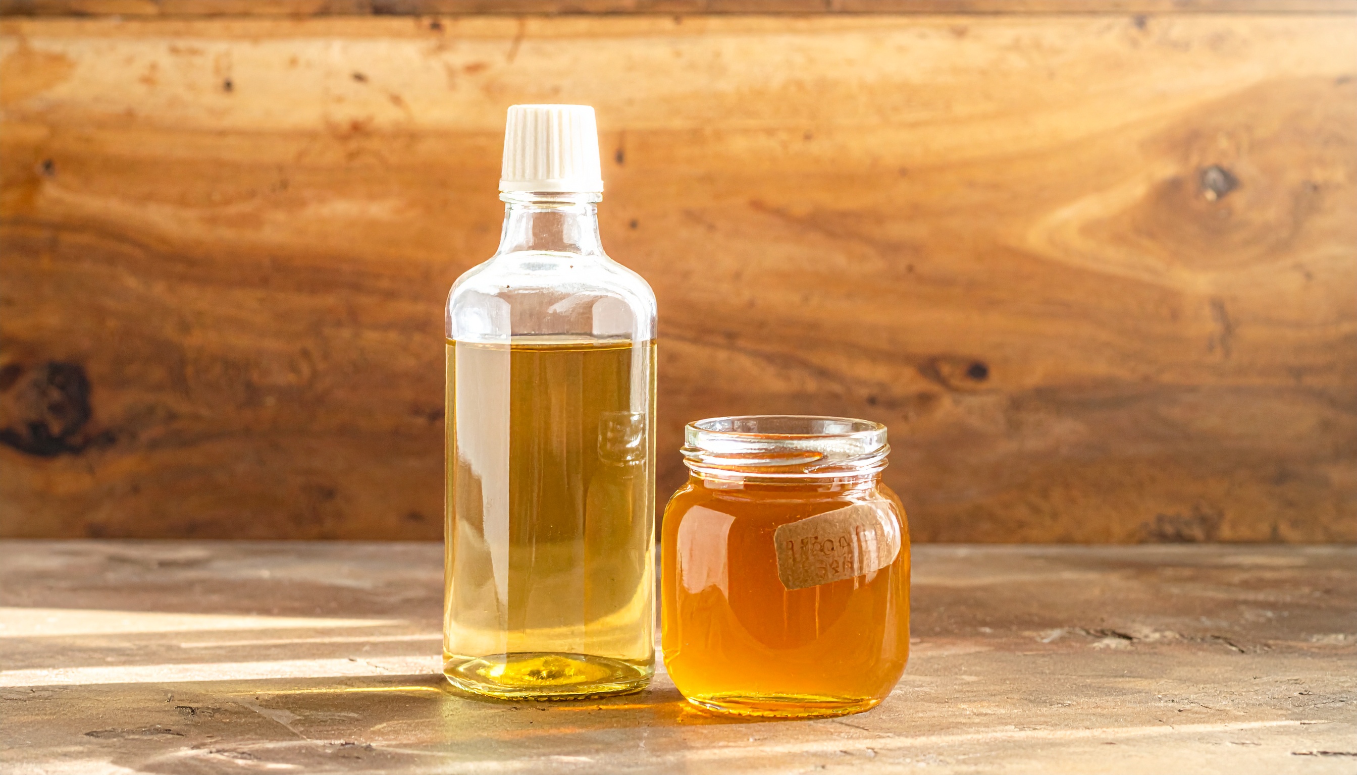 comparison of corn syrup bottle vs organic tapioca syrup in a glass jar side by side - Steve's Goods CBD