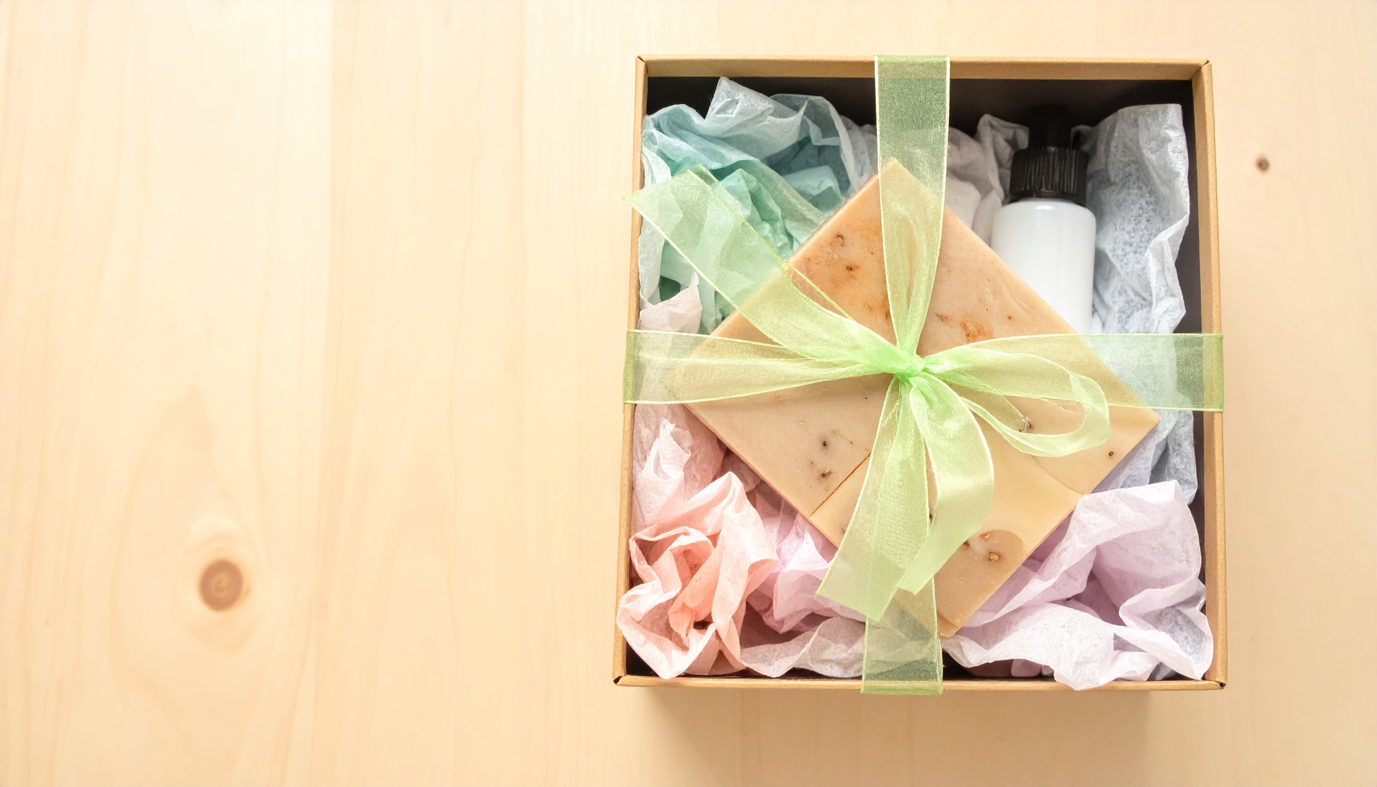 gift box with wellness products nestled in tissue paper ribbon and bow holiday gift - Steve's Goods CBD