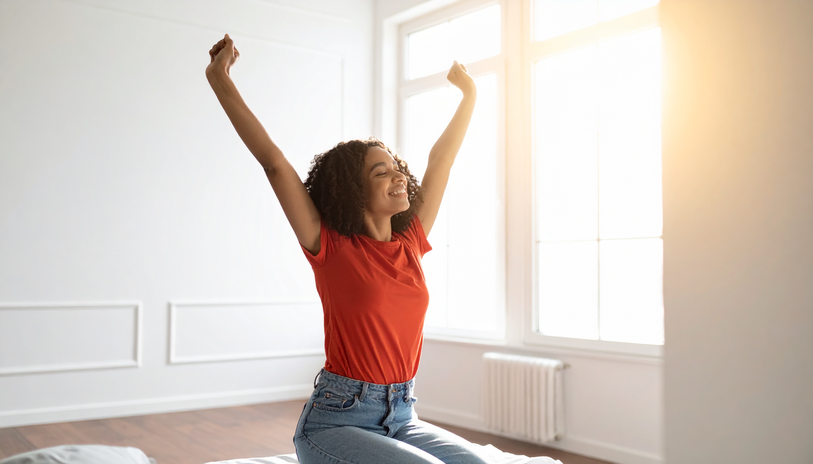 person starting their morning with enthusiasm stretching arms up toward a sunny wind - Steve's Goods CBD