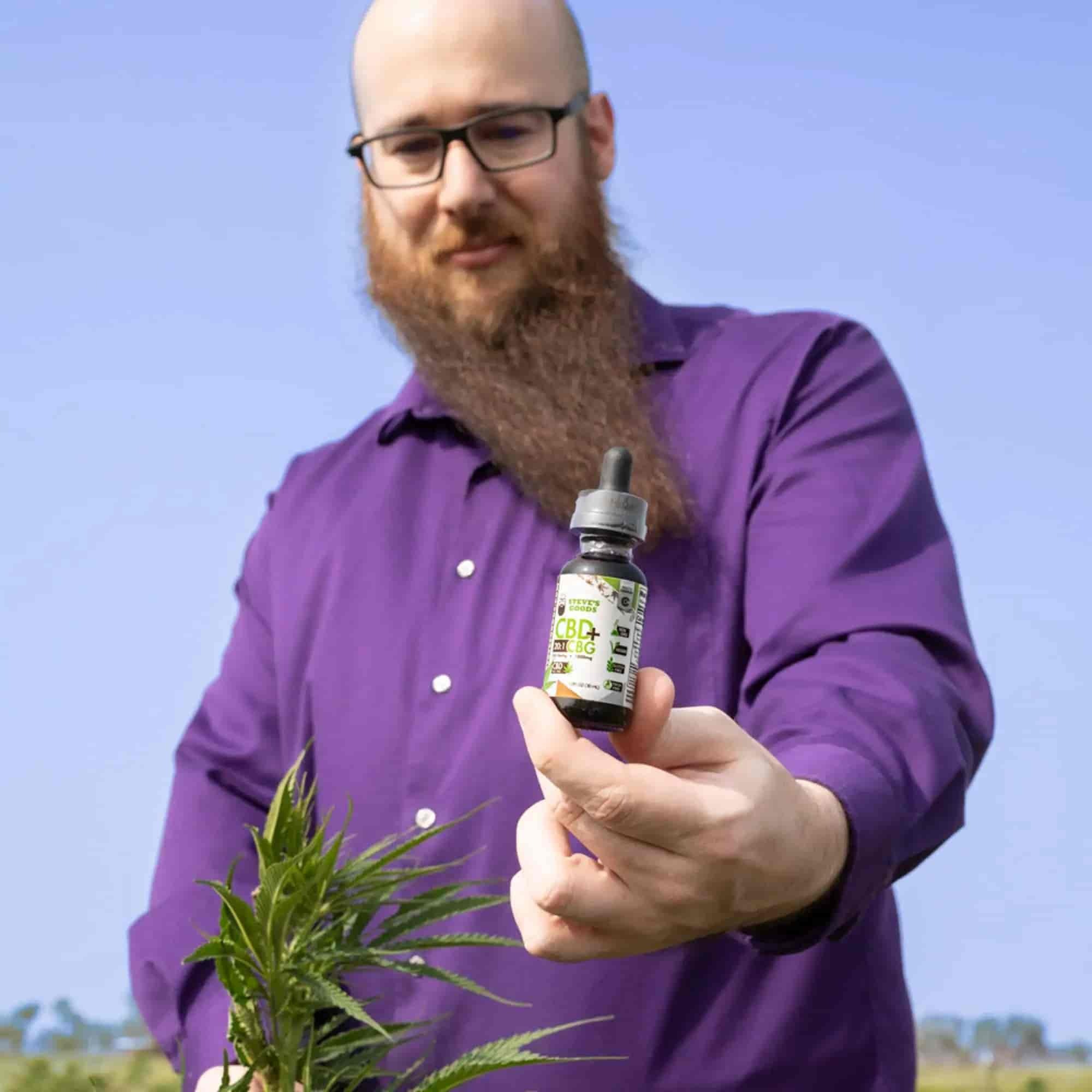 steve-in-field-with-cbg-oil.jpg