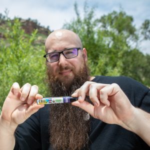 steve-holding-cbd-vape-cartridge